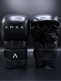 Black MMA gloves with 'AMKA' branding on a dark background